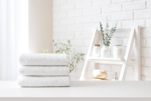 Spa towel stack on white table on bathroom interior background stock photo
