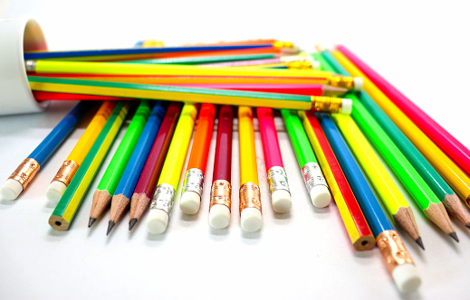 Pencils of different colors on table background