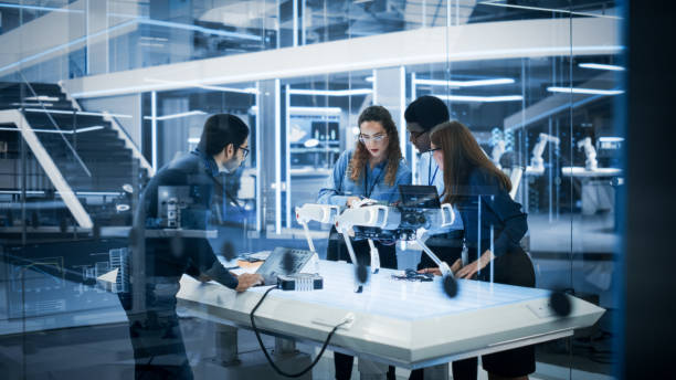 istock Diverse Colleagues Work in Industrial Robotics Factory, Experimenting With a Mobile Robot Prototype. Scientists Use Computers to Program the Robot Dog Before Development Testing. 1482147334