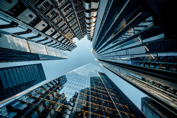 Looking directly up at the skyline of the financial district in central London - creative stock image stock photo