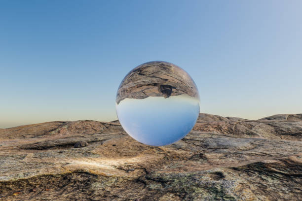 istock single glas sphere ball hovering in the air in large empty desert environment; abstract surreal concept; 3D Illustration 1482147838