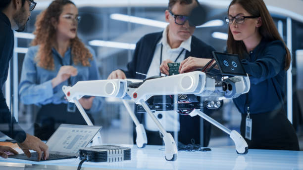 istock Professional Multicultural Team of Female and Male Engineers Use Industrial Programmable Robot Animal in a Factory Development Workshop. Tech Facility with Machines, Computers and Research Equipment. 1482148665