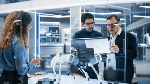 istock Professional Multicultural Team of Female and Male Engineers Work On Industrial Programmable Robot Dog in a Factory Development Workshop. Tech Facility with Machines, Computers and Research Equipment. 1482148756