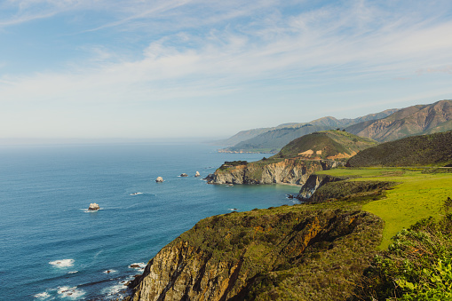 View of scenic rocky coastline during sunny day in Big Sur, California