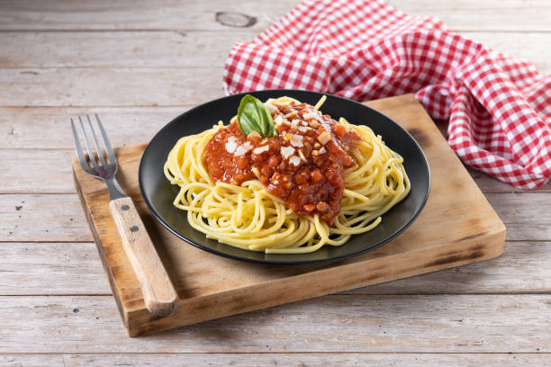 istock Spaghetti with bolognese sauce on wooden table 1482150118