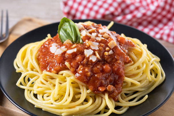 istock Spaghetti with bolognese sauce on wooden table 1482150151