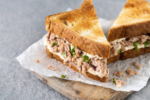 istock Tuna sandwich with mayo and vegetables on gray stone background. 1482150286
