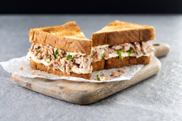 istock Tuna sandwich with mayo and vegetables on gray stone background. 1482150290