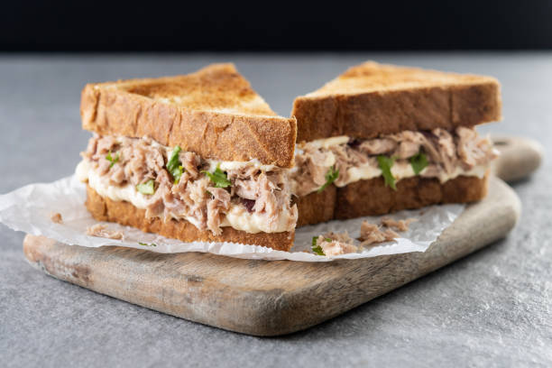 istock Tuna sandwich with mayo and vegetables on gray stone background. 1482150312