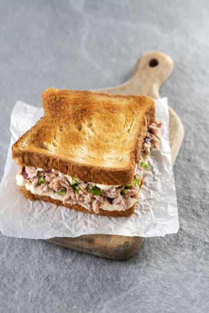 istock Tuna sandwich with mayo and vegetables on gray stone background. 1482150320