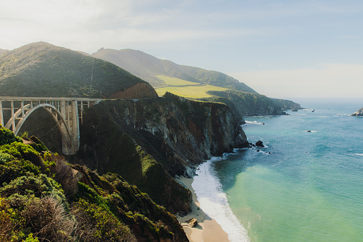 Panoramic landscape of beautiful old bridge by the ocean between the mountains on Monterey peninsula, the USA
