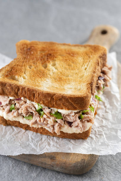 istock Tuna sandwich with mayo and vegetables on gray stone background. 1482150368