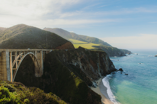 Panoramic landscape of beautiful old bridge by the ocean between the mountains on Monterey peninsula, the USA