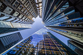 Looking directly up at the skyline of the financial district in central London - creative stock image