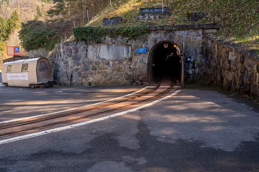 Bex, Vaud Canton, Switzerland - 8 April 2023: Rails and entrance to Bex salt mine tunnel.