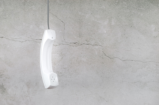 White phone handset with soft shadow on gray