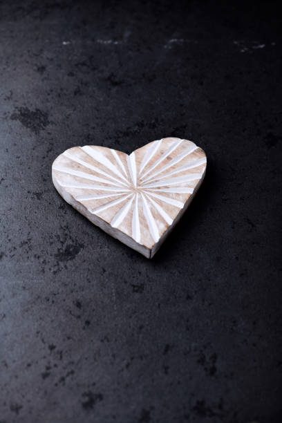 istock Wooden Heart on dark stone background. Soft focus. Copy space. 1482155448