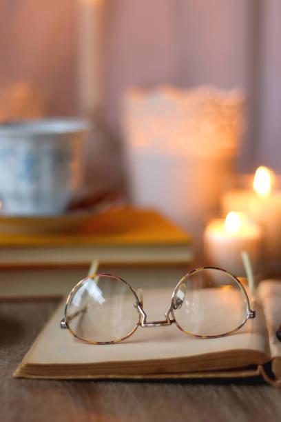 istock Books, Glasses, E-Reader, Pen, Tea, Cookies and Candles 1482157868