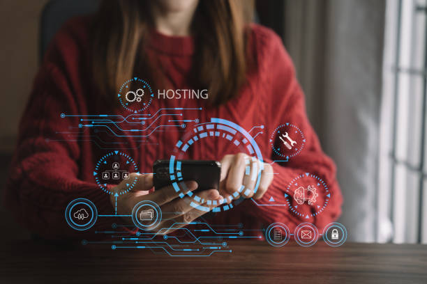 istock Woman using smartphone and presses his finger on the virtual screen inscription Hosting on desk, Web hosting concept, Internet, business, digital technology concept. 1482164008