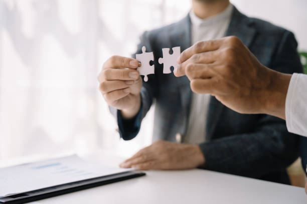 istock Business people asian with jigsaw puzzle pieces in office, Successful teamwork and partnership concept. 1482164021