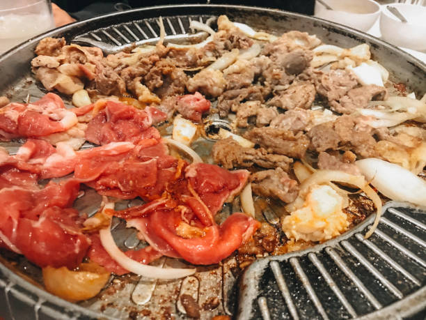 istock sliced raw beef and chicken meat roasting on the steel grating 1482165529