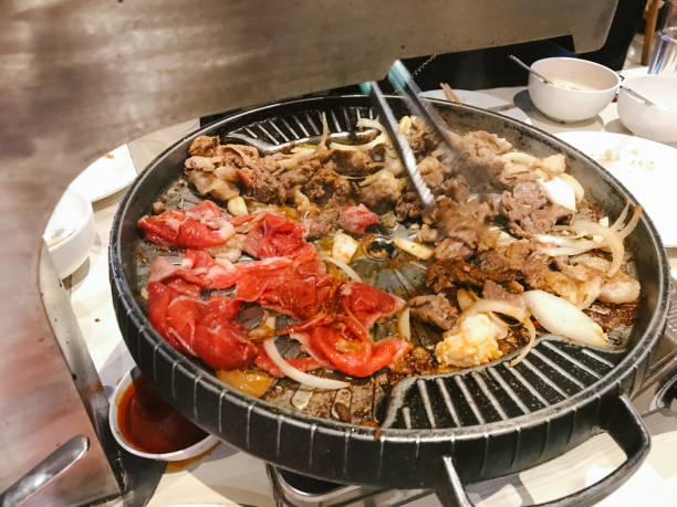 istock sliced raw beef and chicken meat roasting on the steel grating 1482165690