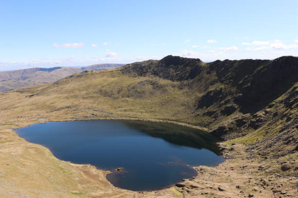 View over Red Tarn towards Striding Edge and Helvellyn, Lake District View over Red Tarn towards Striding Edge and Helvellyn, Lake District striding edge stock pictures, royalty-free photos & images