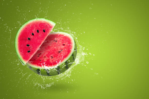 istock Water splashing on Sliced watermelon fruit isolated on green background 1482167023