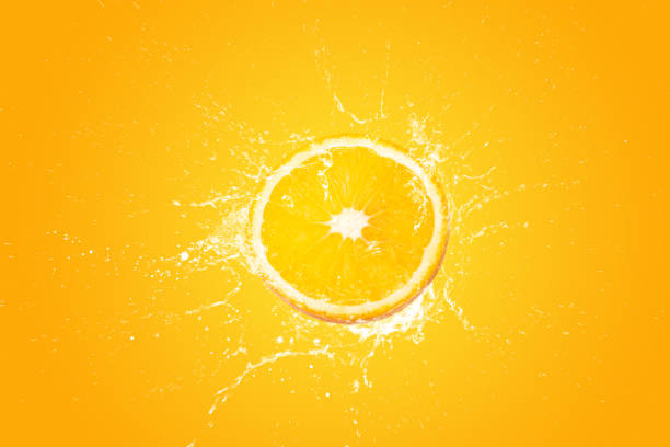 istock Creative layout made from Fresh Sliced oranges and Orange fruit and water Splashing on a orange background. 1482167025