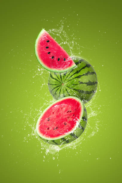 istock Water splashing on Sliced watermelon fruit isolated on green background 1482167026