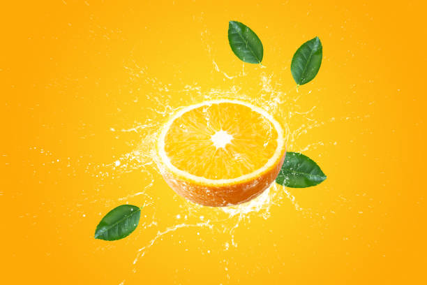istock Creative layout made from Fresh Sliced oranges and Orange fruit and water Splashing on a pink background. 1482167035