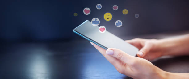 istock Woman's hands holding mobile phone on the black background. 1482167328