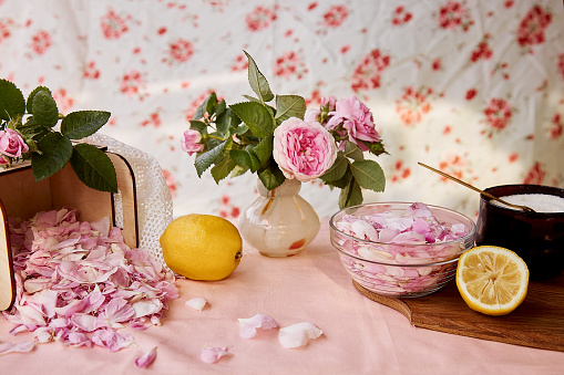 Homemade natural tea rose jam preparing with sugar, lemon and tea rose petals. Healthy recipe. Rustic ingredients. Lifestyle photography.