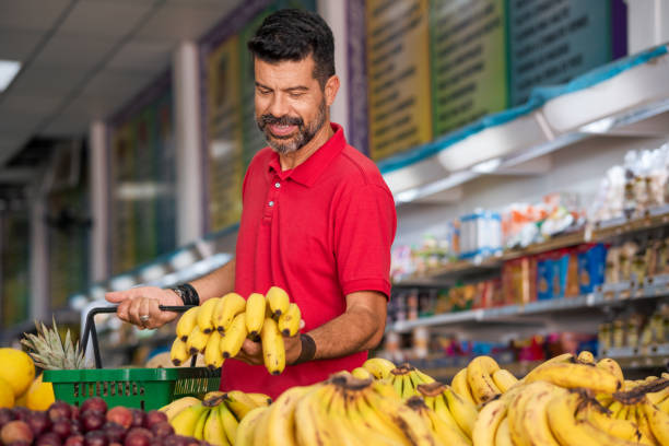 Consumer chooses fruit in supermarket