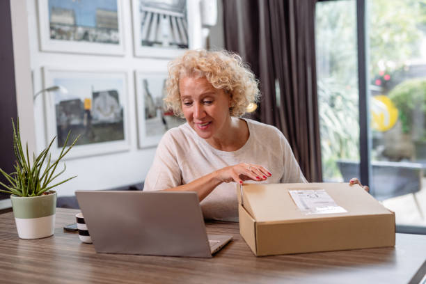 istock Mature woman unboxing a package 1482169731