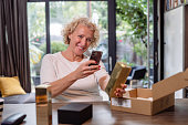 Mature woman taking a photo of a product that she bought