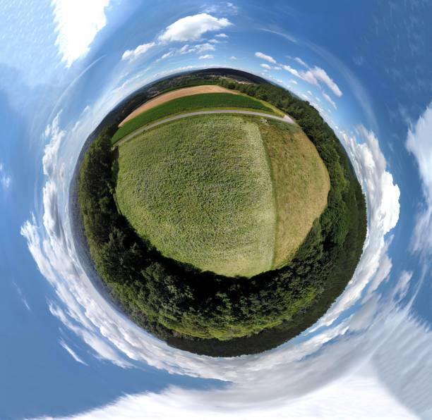 istock 360-degree green field with trees against a blue sky with clouds. 1482170280