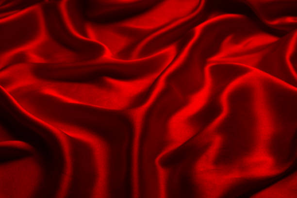 istock Red silk or satin luxury fabric texture can use as abstract background. 1482174383