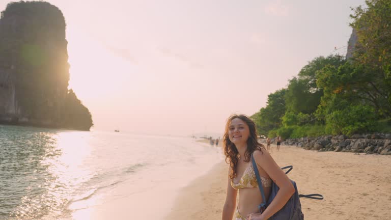 Woman walking on Railey beach and looking at stunning scenery