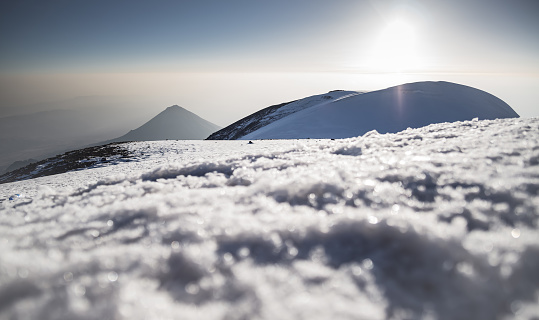 Ski on top of a mountain - Wilder Kaiser Mountain range (Austria) in the background