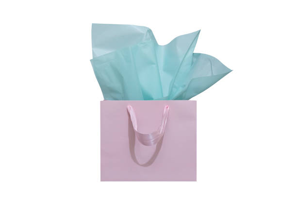 白い背景にティッシュペーパーとクラフト紙のギフトバッグ - shopping bag orange bag handle ストックフォトと画像