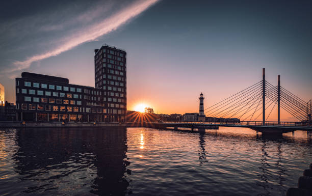 istock Summer sunset with University bridge and the old lighthouse from 1878 in Malmo harbour, Sweden. 1482180577