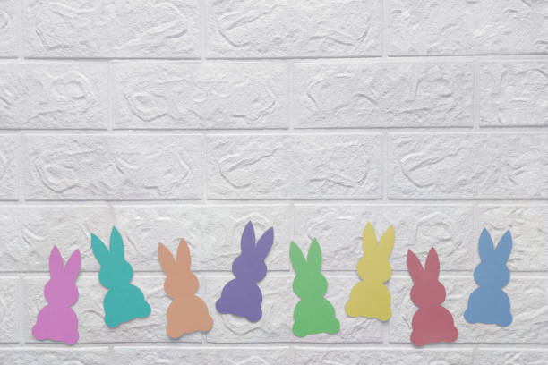 istock White wall with paper bunnies. Place for text. 1482185282