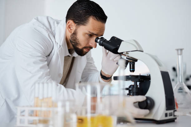 istock Science, microscope and research with a doctor man at work in a laboratory for innovation or development. Medical, analytics and biotechnology with a male scientist working in a lab for breakthrough 1482187453