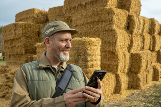 istock Farmer in front of straw bales. 1482189765