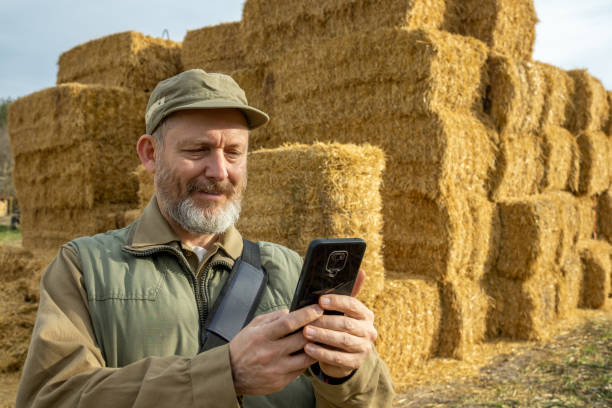 istock Farmer in front of straw bales. 1482189771