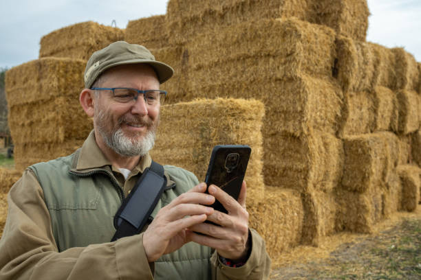istock Farmer in front of straw bales. 1482189818