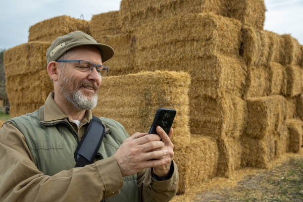 istock Farmer in front of straw bales. 1482189827