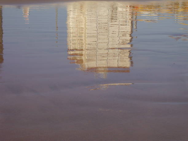 Reflection of a building on the shore