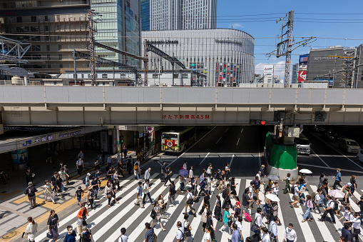 Osaka, Japan - August 19, 2022 : Pedestrians walk past the JR Osaka Station in Osaka, Japan. It is a major railway station in the Umeda of Kita-ku, Osaka, Japan.